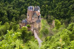an old castle on a hill in the forest at Ferienwohnung Alte-Schule-Kail Wohnung 2 in Kail