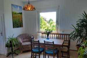 a dining room with a table and chairs and a window at Ferienwohnung Alte-Schule-Kail Wohnung 2 in Kail