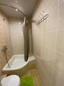a bathroom with a toilet and a shower and a sink at Hotel Guest House GOLDEN DEGREZ in Bukhara +76 photos