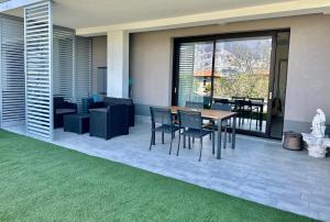 a patio with a table and chairs and a couch at La Casa di Ada in Iseo