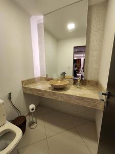 a bathroom with a sink and a toilet at Casa de praia mangaratiba in Mangaratiba