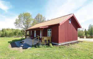 a red tiny house with a porch on a field at Nice Home In Hinds With 1 Bedrooms And Wifi in Hindås