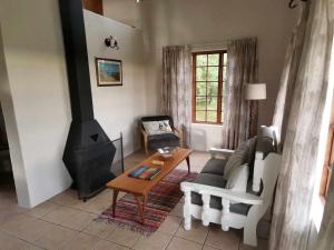 a living room with a couch and a wood stove at Eagles' Rock in Underberg