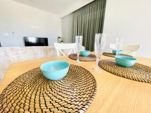 a table with bowls and glasses on top of it at Vixen Apartment Studio 2 in Theologos