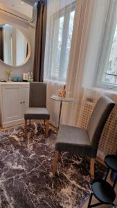 - un salon avec une chaise, une table et un miroir dans l'établissement Elegance Wien, à Vienne