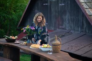 a woman standing at a table with food on it at Libling Štiavnický in Banská Štiavnica