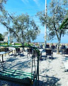 a park with chairs and tables and trees and a swing at De La Terrasse IZNIK in İznik