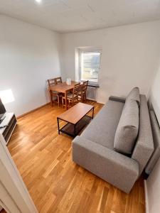 HBA Appartsments في مالمو: غرفة معيشة مع أريكة وطاولة