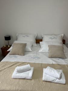 a large white bed with two towels on it at Apartment Ana in Imotski