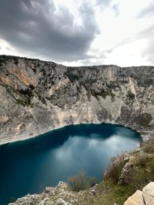 a blue lake in the middle of a canyon at Apartment Ana in Imotski