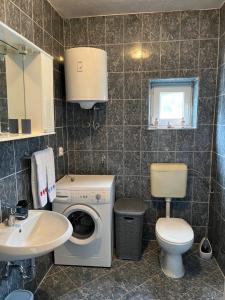 a bathroom with a washing machine and a sink at Apartment Ana in Imotski +15 photos