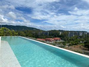a swimming pool with a view of a city at Brand new Condo in Laguna near golf course in Bang Tao Beach