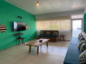 a living room with a couch and a flat screen tv at Casa 1090 ubicada cerca a todo. in Leticia