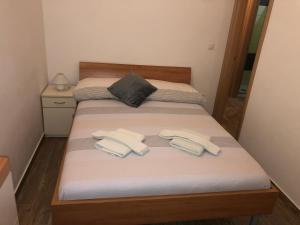 2 posti letto in una piccola stanza con asciugamani di Apartmani Ivana a Cres