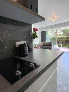 a kitchen with a black and white counter top at Croisette pearl in Cannes