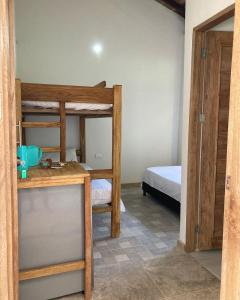 a room with two bunk beds and a bed at Habitación privada en la playa HappyBeach_co in San Antero