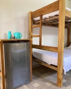 a room with two bunk beds and a television at Habitación privada en la playa HappyBeach_co in San Antero