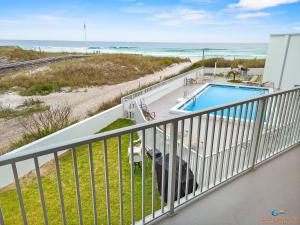 a balcony with a swimming pool and the beach at IS9-Cozy Upstairs Beachfront Condo - King Beds in Fort Walton Beach