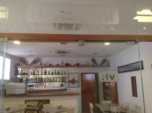 a dining room with a counter and a bar at Vehí in Cadaqués