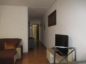 a living room with a couch and a flat screen tv at Casa Valente in Macedo de Cavaleiros