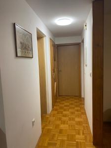 a hallway with a wooden floor and a door at MARIA in Varaždin