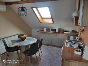 a small kitchen with a table and a window at MARIA in Varaždin