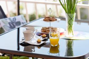 a glass table with a tray of food and drinks at Luxa 5 min old town, 10 min airport in Trogir