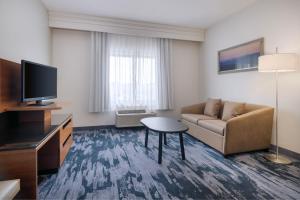 a living room with a couch and a tv at Fairfield Inn & Suites Orlando Ocoee in Orlando