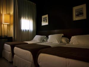 Postel nebo postele na pokoji v ubytování Hostal Badaloní