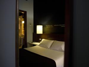 Postel nebo postele na pokoji v ubytování Hostal Badaloní