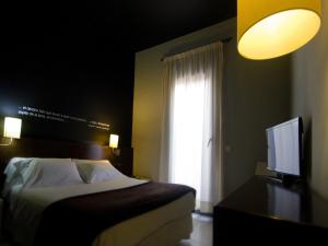 Postel nebo postele na pokoji v ubytování Hostal Badaloní