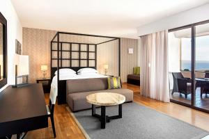 a bedroom with a bed and a living room at Sheraton Rhodes Resort in Ixia