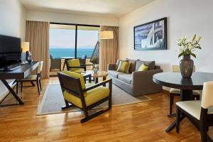 a living room with a couch and a table at Sheraton Rhodes Resort in Ixia
