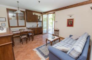 a living room with a blue couch and a kitchen at Borgo Caiano Country Inn in Caiano