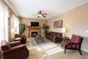a living room with leather furniture and a fireplace at 4BR Walk-in - Pool Table - Fire Pit - FREE TICKETS INCLUDED - DV164 in Branson