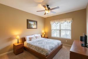 a bedroom with a bed and a ceiling fan at 4BR Walk-in - Pool Table - Fire Pit - FREE TICKETS INCLUDED - DV164 in Branson