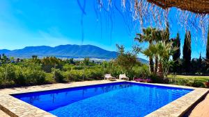 a swimming pool with a view of the mountains at Finca La Panorámica in Alhaurín el Grande