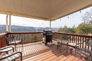 a screened in porch with chairs and a grill on it at 4BR Walk-in - Pool Table - Fire Pit - FREE TICKETS INCLUDED - DV164 in Branson