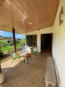 a patio with chairs and a table on a patio at La Piña, Rio Celeste in Rio Celeste