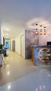 a lobby of a building with a sign on the wall at Hostal Casa San Pedro in Santa Marta