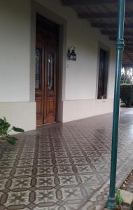 a building with a door and a tiled floor at Casa Quinta in Colonia Caroya