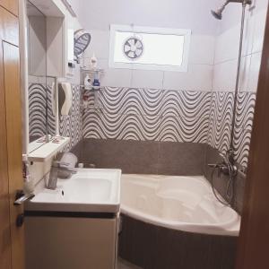 een badkamer met een bad en een wastafel bij White Lotus Corporate Business Boutique in Karachi