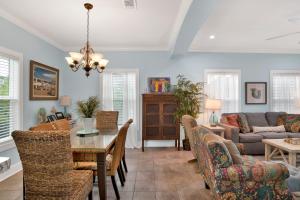 a living room with a table and chairs and a couch at Boogie Man 36C By Pkrm in Pensacola