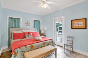 a bedroom with a bed and a chair and a window at Boogie Man 36C By Pkrm in Pensacola +27 photos