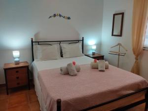 a bedroom with a bed with two pillows on it at Casa Guerreiro in Longueira
