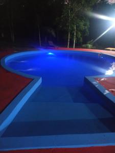 een blauw zwembad met verlichting bij Quinta Don Adolfo in Puerto Iguazú