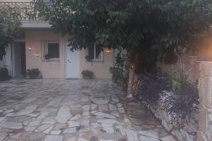 a house with a stone driveway in front of it at Efi Studio 2 Lamia in Lamía