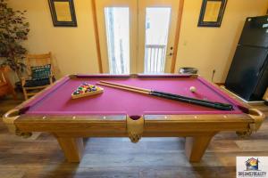 a pool table with balls and chopsticks on it at Forest Heights Lodge - 6BR - Pool Table - Near Silver Dollar City - FREE TICKETS INCLUDED in Branson
