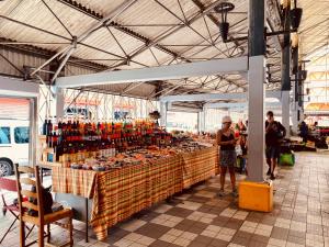 a group of people standing in a market with a large display at LOFT T2 en couleur en plein centre ville Fort-De-France Martinique in Fort-de-France