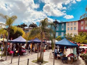 an outdoor market with tents and palm trees at LOFT T2 en couleur en plein centre ville Fort-De-France Martinique in Fort-de-France